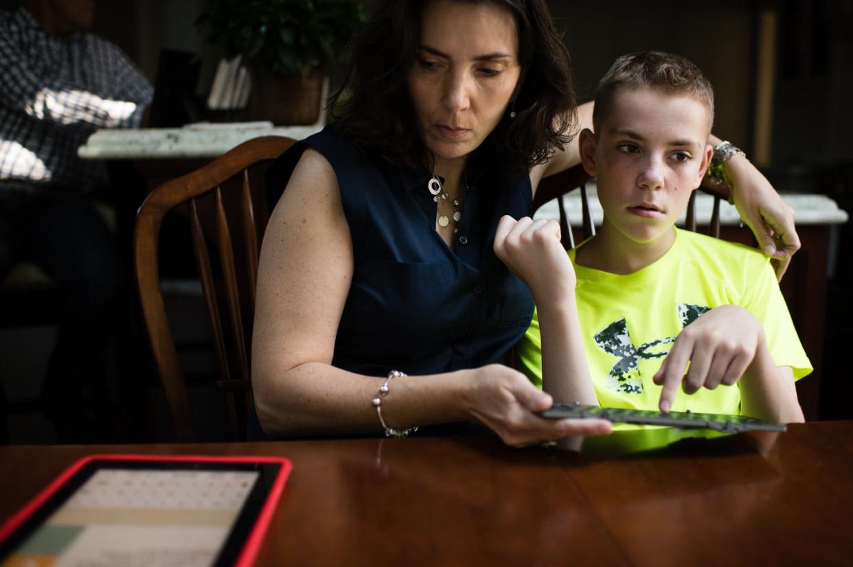 <span class="caption">Mike Keller, a 13-year old boy with autism, uses a keyboard and iPad to communicate with his mother, Lori Mitchell-Keller.</span> <span class="attribution"><a class="link " href="https://www.gettyimages.com/detail/news-photo/mike-keller-a-13-year-old-boy-with-autism-uses-a-keyboard-news-photo/646551868?adppopup=true" rel="nofollow noopener" target="_blank" data-ylk="slk:Sarah L. Voisin/The Washington Post via Getty Images;elm:context_link;itc:0;sec:content-canvas">Sarah L. Voisin/The Washington Post via Getty Images</a></span>