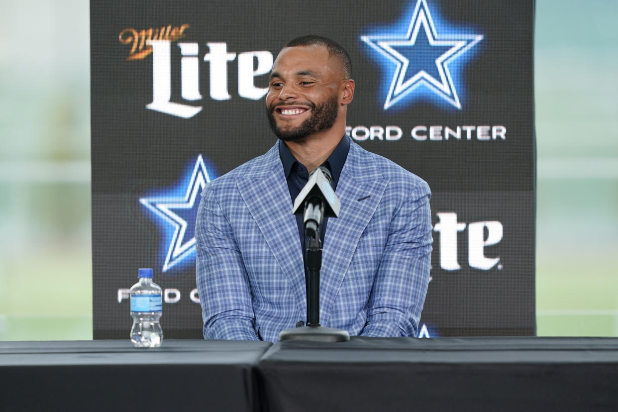 Dallas Cowboys quarterback Dak Prescott smiles during a news conference at the team's NFL football practice facility in Frisco, Texas, Wednesday, March 10, 2021. The Cowboys and Prescott have finally agreed on the richest contract in club history, two years after negotiations began with the star quarterback. (AP Photo/LM Otero)