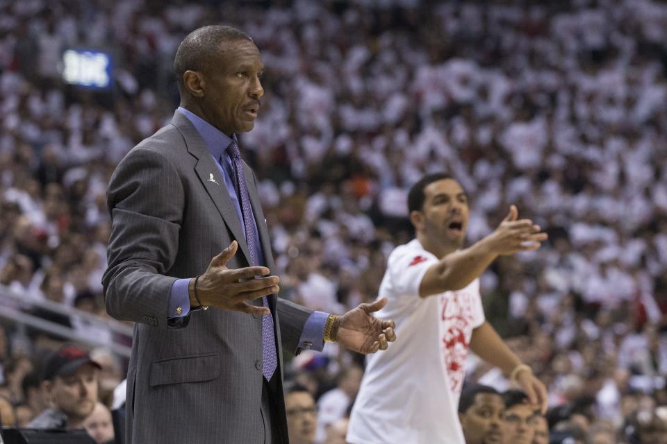 Toronto Raptors coach Dwane Casey and rapper Drake react during the Raptors' 94-87 loss to the Brooklyn Nets in Game 1 of an opening-round NBA basketball playoff series, in Toronto on Saturday, April 19, 2014. (AP Photo/The Canadian Press, Chris Young)