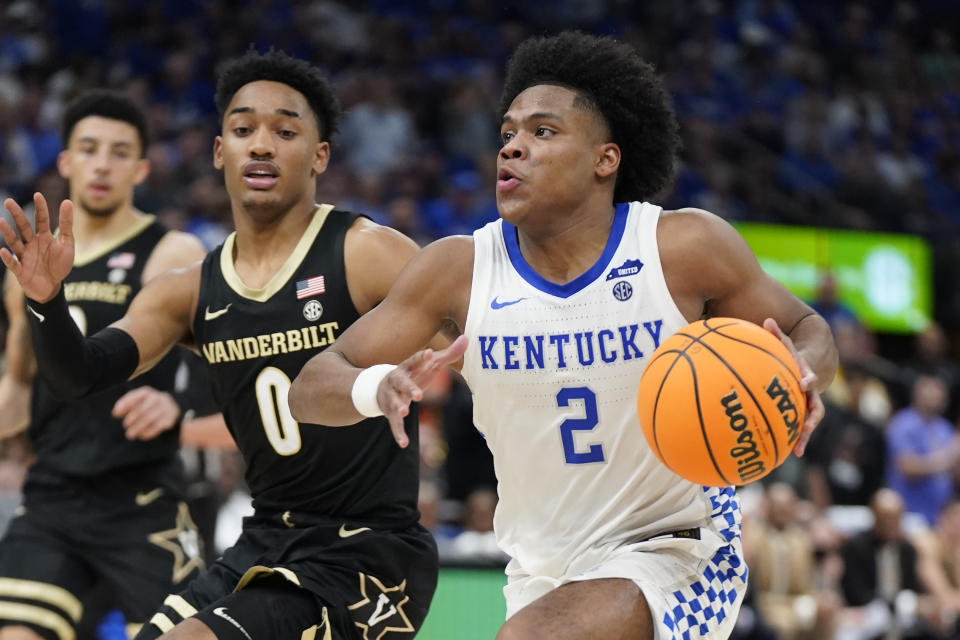 Kentucky guard Sahvir Wheeler (2) drives past Vanderbilt guard Tyrin Lawrence (0) during the second half of an NCAA college basketball game in the Southeastern Conference men's tournament Friday, March 11, 2022, in Tampa, Fla. (AP Photo/Chris O'Meara)