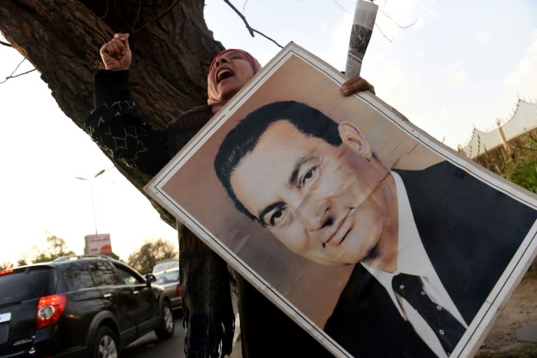 Supporters of Egypt's former president Hosni Mubarak chant slogans outside Maadi military hospital in Cairo on March 2, 2017