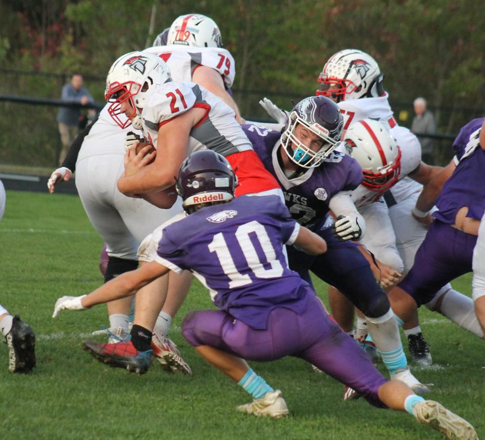 Marshwood's Landon Waterman (10) and Shane Waterman converge on Sanford's Jordan Bissonnette during Friday night's contest in South Berwick, Maine.