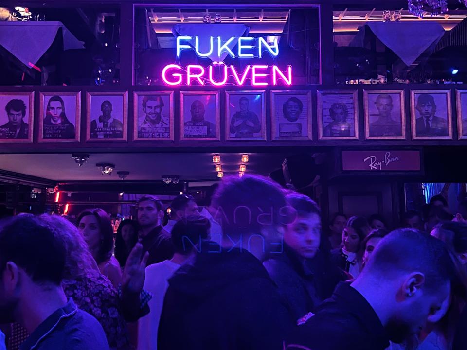 people milling about a rock and roll bar in athens greece