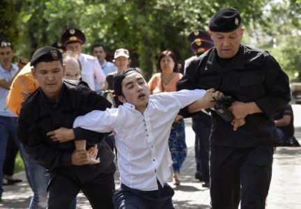 Police officers detain an opposition supporter attempting to stage a protest rally in Almaty, Kazakhstan June 23, 2018.  REUTERS/Mariya Gordeyeva