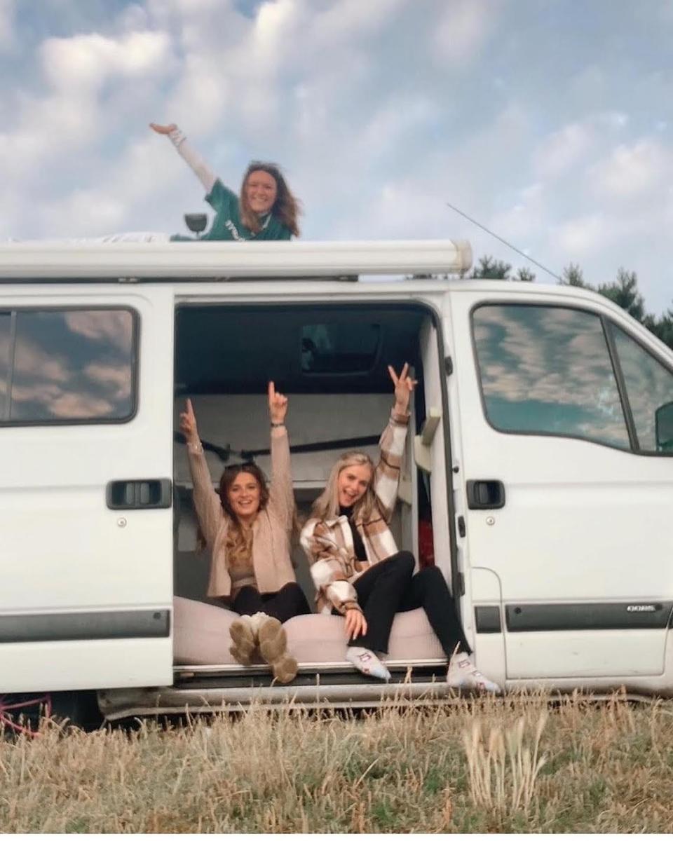 3 girls sat in a van