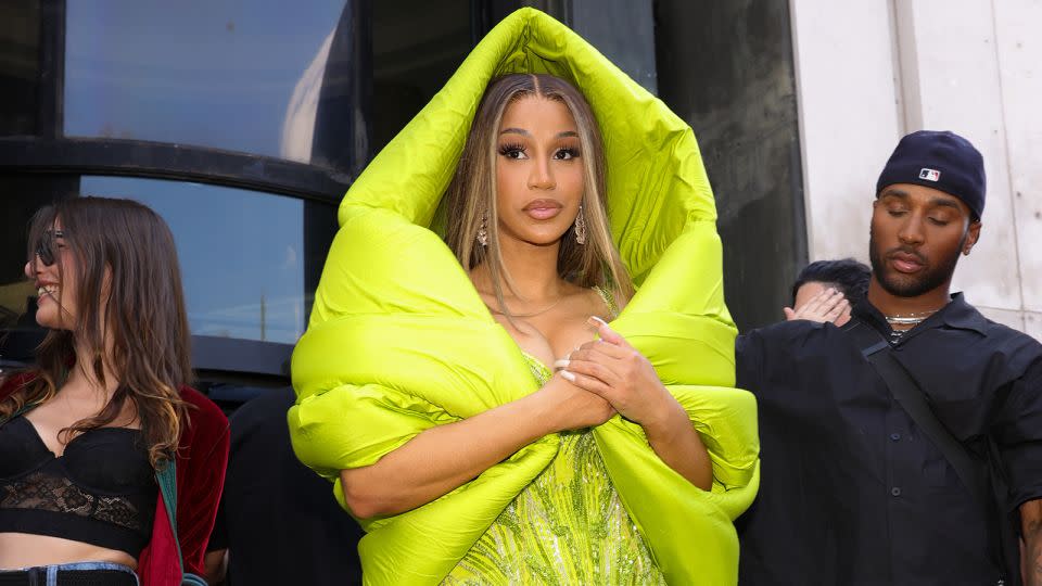 Cardi B was spotted at several shows throughout Haute Couture Week. For the Gaurav Gupta catwalk she wore a lime green embellished hooded gown. - Pierre Suu/GC Images/Getty Images