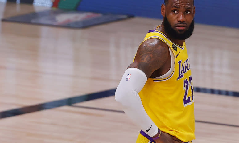 LeBron James looks onto the court against the Nuggets.