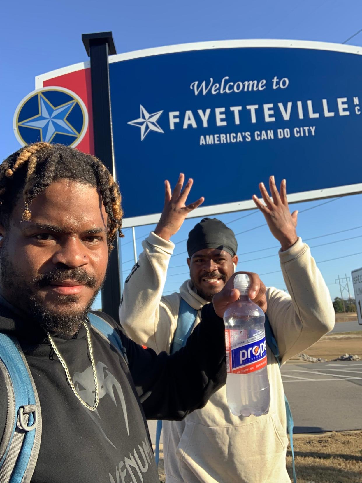 Davon and Tavon Woods pose as they make it to Fayetteville, North Carolina. The twins are walking to raise awareness of the challenges faced by children in foster care. They're expecting to make it to Philadelphia on Dec. 31.