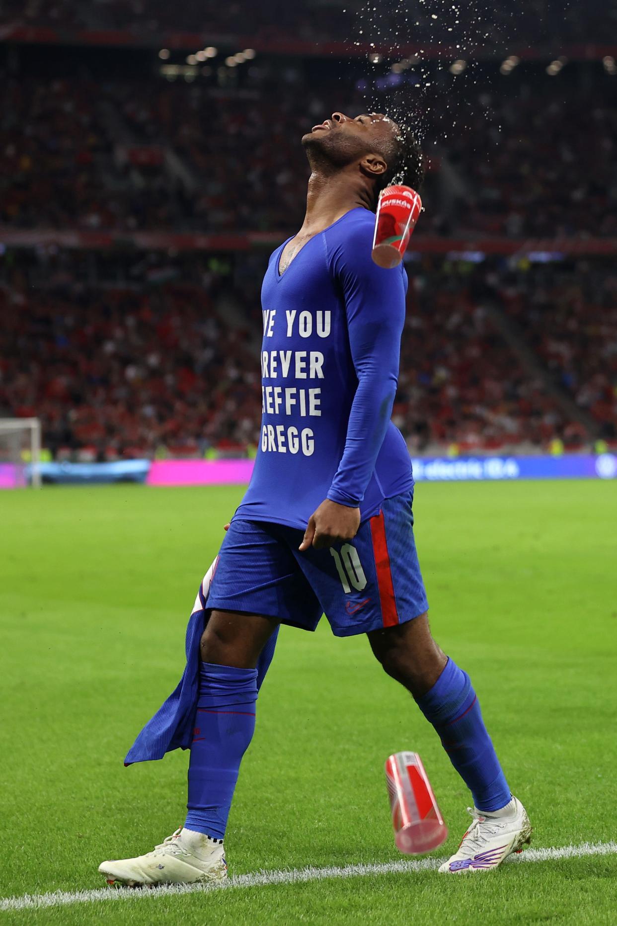 Raheem Sterling of England celebrates after scoring their team's first goal wearing a t-shirt that reads "Love You Forever Steffie Gregg" during the 2022 FIFA World Cup Qualifier match between Hungary and England at Stadium Puskas Ferenc on September 02, 2021 in Budapest, Hungary.