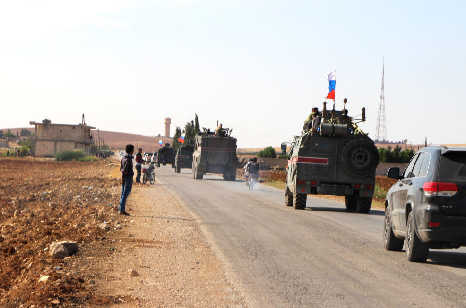 Russian forces armored vehicles patrol the Syrian border in Kobani, Wednesday, Oct. 23, 2019. Russian military police began patrols on part of the Syrian border Wednesday, quickly moving to implement an accord with Turkey that divvies up control of northeastern Syria. (AP Photo)