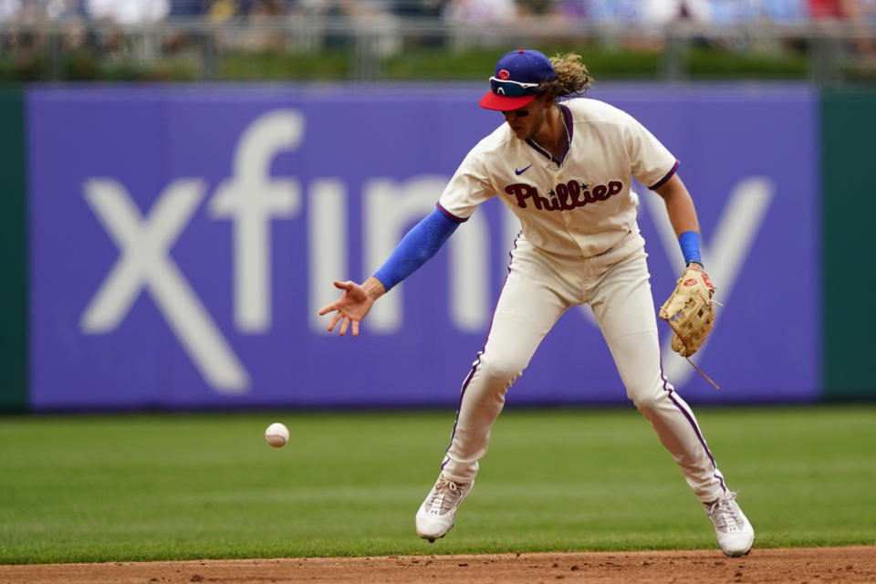 Philadelphia Phillies third baseman Alec Bohm cannot hang on to a fielder's choice by New York Mets' Mark Canha during the second inning of a baseball game, Sunday, Aug. 21, 2022, in Philadelphia. (AP Photo/Matt Slocum)