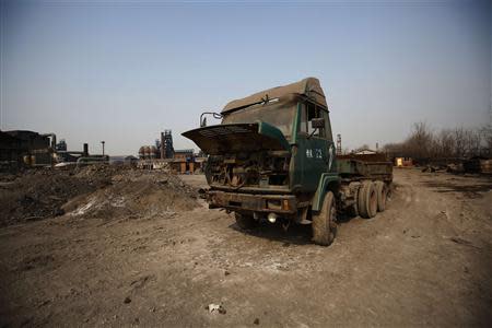 A truck with its hood cover opened is pictured inside an abandoned steel mill of Qingquan Steel Group in Qianying township, Hebei province February 18, 2014. REUTERS/Petar Kujundzic