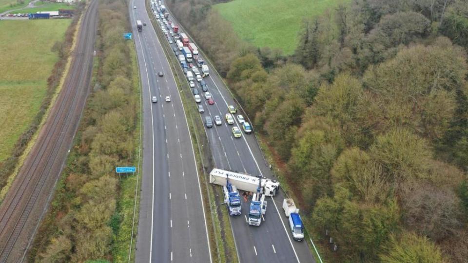 Aerial image of overturned lorry on the M5 with traffic building