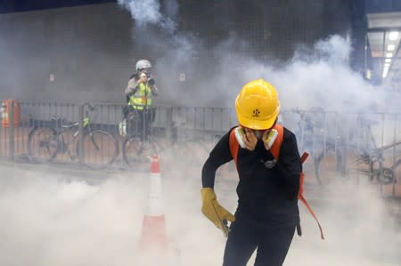 An anti-extradition bill protester reacts after tear gas was fire by the police during a demonstration in Tai Wai in Hong Kong