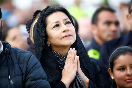 A woman gestures as Pope Francis celebrates holy mass at Simon Bolivar park in Bogota, Colombia September 7, 2017. REUTERS/Stefano Rellandini