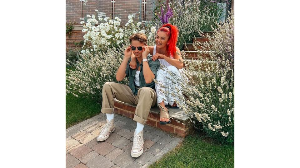 The couple were pictured seated in a colourful garden