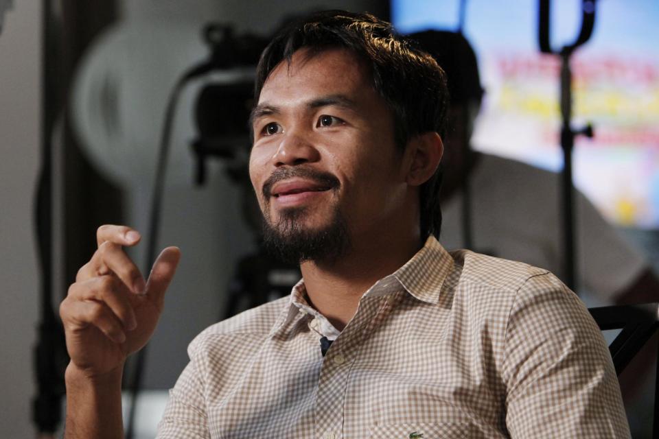 Boxer and politician Manny Pacquiao speaks about his views on same-sex marriage, and other subjects, during the taping of a television segment for the show "Extra" at his home in Los Angeles, Wednesday, May 16, 2012. Pacquiao was quoted in a recent interview as opposing President Barack Obama's views on same-sex marriage. (AP Photo/Reed Saxon)