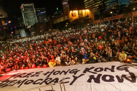 Demonstrators wave their smartphones during a rally ahead of the G20 summit, urging the international community to back their demands for the government to withdraw a the extradition bill in Hong Kong