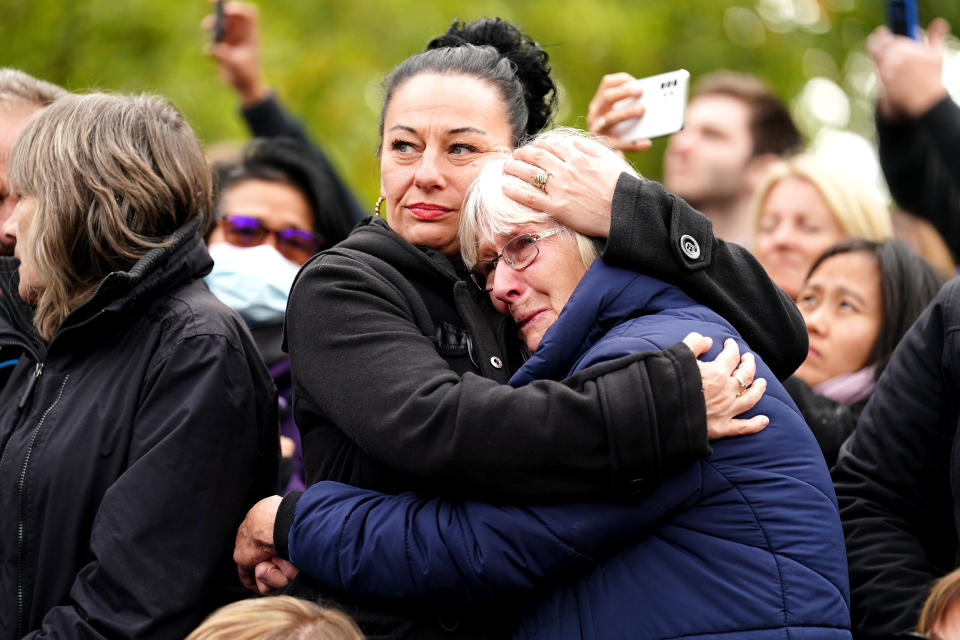 Members of the crowd on The Mall listen to the State Funeral of Queen Elizabeth at Westminster Abbey, London. Picture date: Monday September 19, 2022.