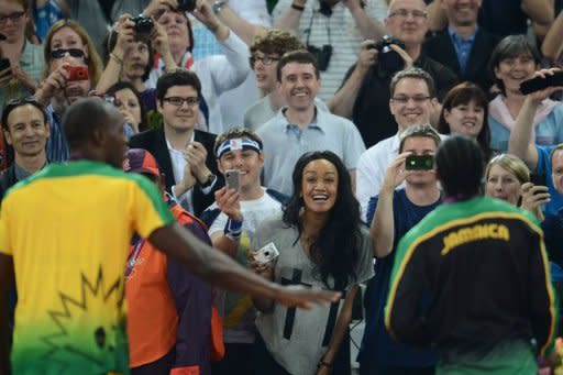 Gold medalist Jamaica's Usain Bolt (L) and silver medalist Jamaica's Yohan Blake pose for spectators during the medal ceremony after the men's 200m final at the athletics event during the London 2012 Olympic Games in London