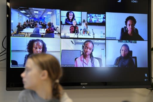 Swedish climate activist Greta Thunberg at the press conference in Stockholm with other participants on screen