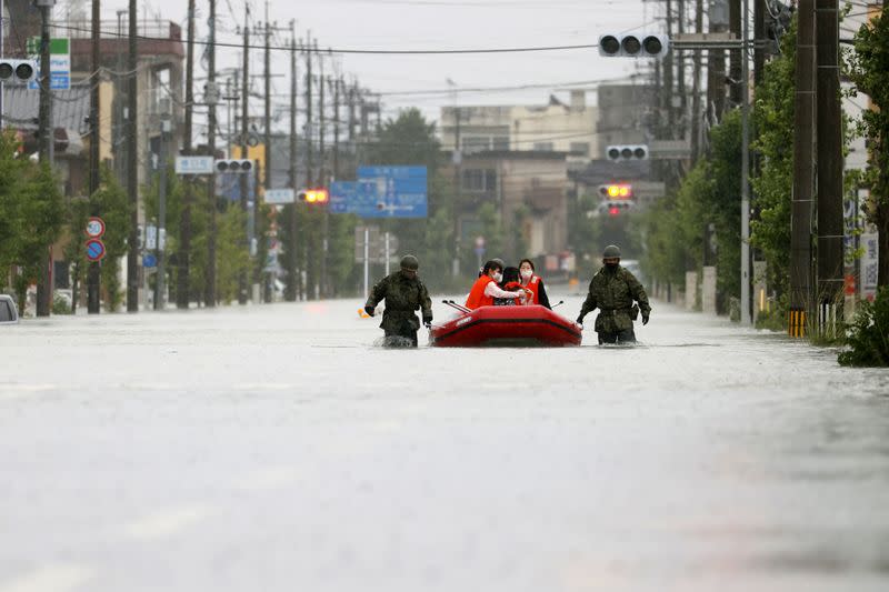 Local residents are rescued by Japan Self-Defense Force soldiers after heavy rain in Omuta