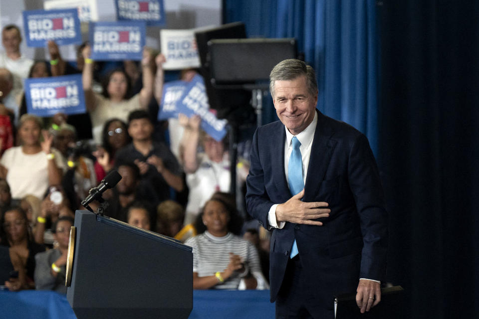 Roy Cooper on stage as supporters cheer (Allison Joyce / AFP via Getty Images file)