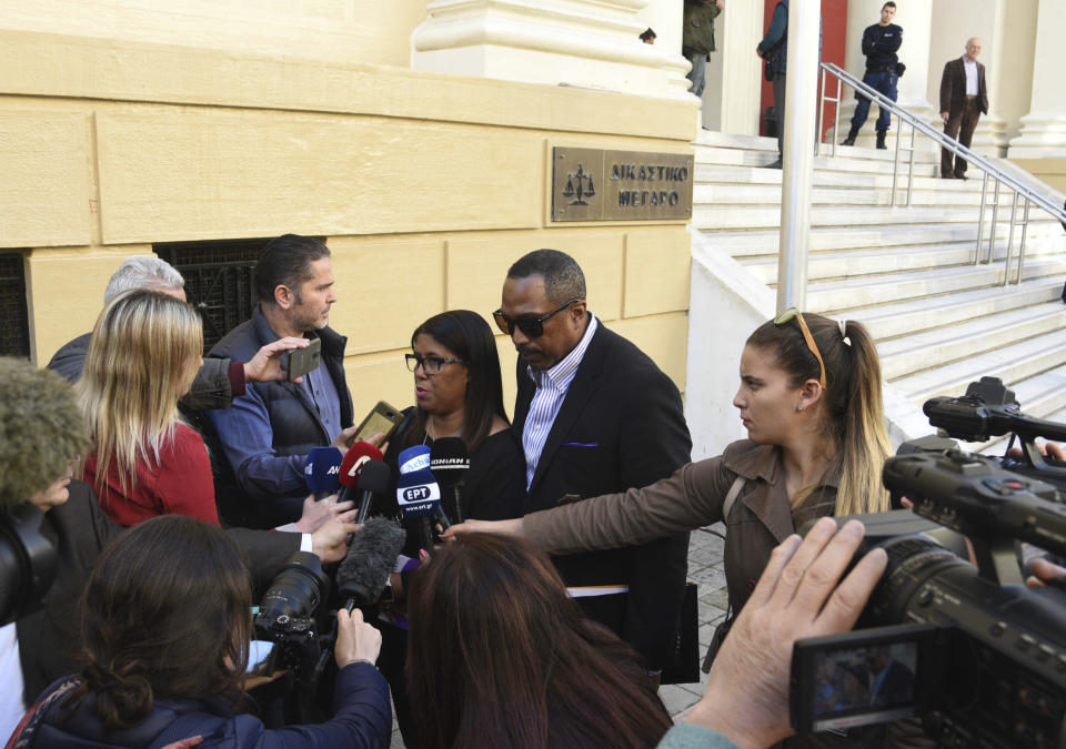 Phil and Jill Henderson, center, parents of Bakari Henderson, face the media outside the court house in Patras, Greece, on Thursday, Nov. 22, 2018. A Greek court on Thursday convicted and sentenced six of nine suspects in the fatal beating of an American tourist in an island resort last year. Bakari Henderson, a 22-year-old of Austin, Texas, died after being beaten in the street following an argument in a bar in the popular Laganas resort area of Zakynthos island in July 2017. (AP Photo/Giannis Androutsopoulos)