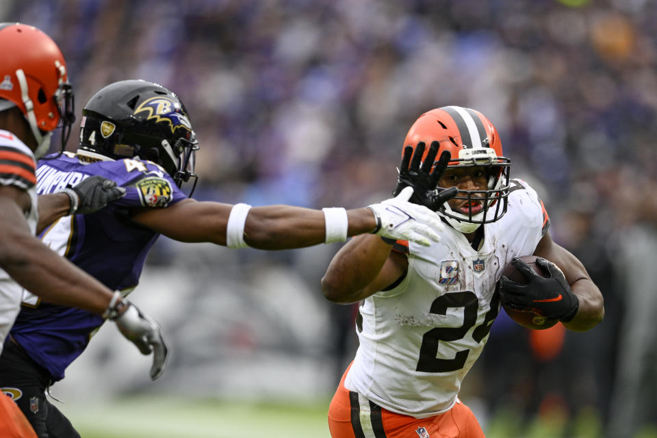 Cleveland Browns running back Nick Chubb (24) tries to get around Baltimore Ravens cornerback Marlon Humphrey (44) in the second half of an NFL football game, Sunday, Oct. 23, 2022, in Baltimore. (AP Photo/Nick Wass)