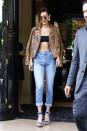 <p>In a snakeskin jacket, Dior black bandeau top, high-waisted jeans, Schutz denim sandals and Robert & Fraud sunglasses while out in Paris. </p>