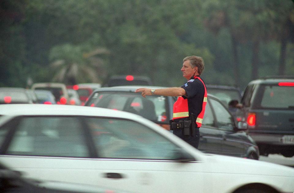 An S.P.D. officer directs traffic at the intersection of Montgomery St and Derenne Ave.  Traffic was backed up due to the increased security at Hunter Army Airfield and the number of motorists trying to enter the post.  photo by John Carrington