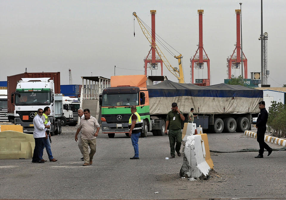 Trucks preparing to leave the port of Umm Qasr after protesters were removed from the entrances by security forces, Iraq, Thursday, Nov. 7, 2019. Iraqi officials say work has resumed in one of the country's largest ports after it was closed for days by anti-government protesters. (AP Photo/Nabil al-Jourani)