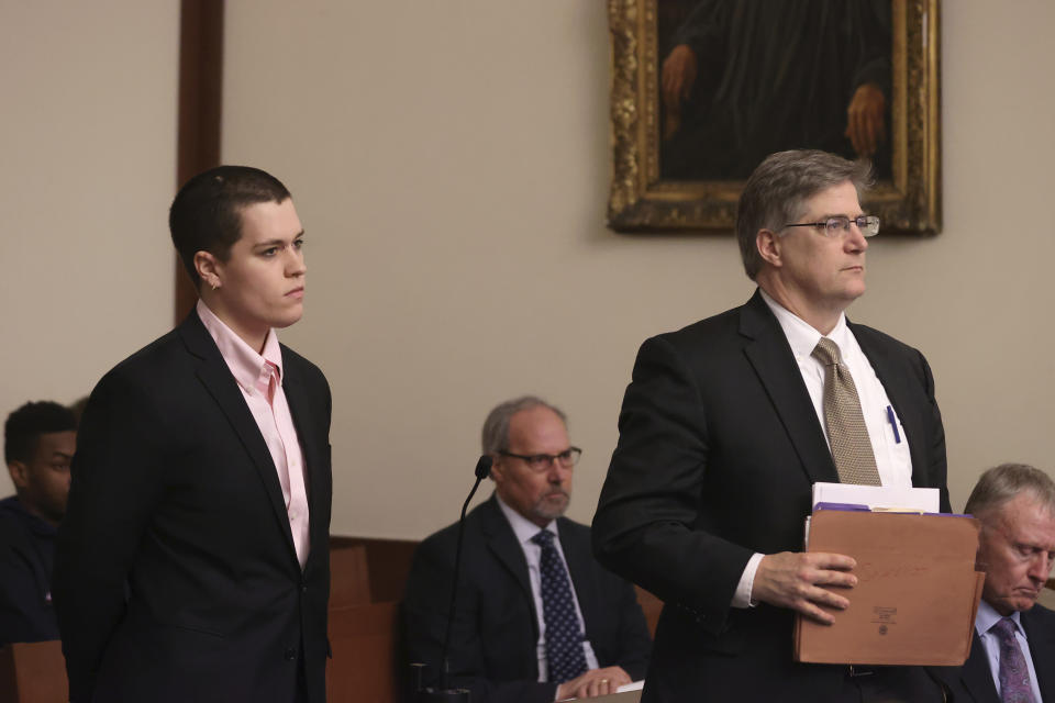 Riley Dowell, left, stands with her attorney during arraignment at Boston Municipal Court, Monday, Jan. 23, 2023. Dowell, the daughter of U.S. Rep. Katherine Clark of Massachusetts was arrested during a protest Saturday night on Boston Common and later charged with assault after a police officer was injured. Dowell, 23, is accused of defacing the Parkman Bandstand Monument with spray paint before she was arrested, officials said. (David L Ryan/The Boston Globe via AP, Pool)