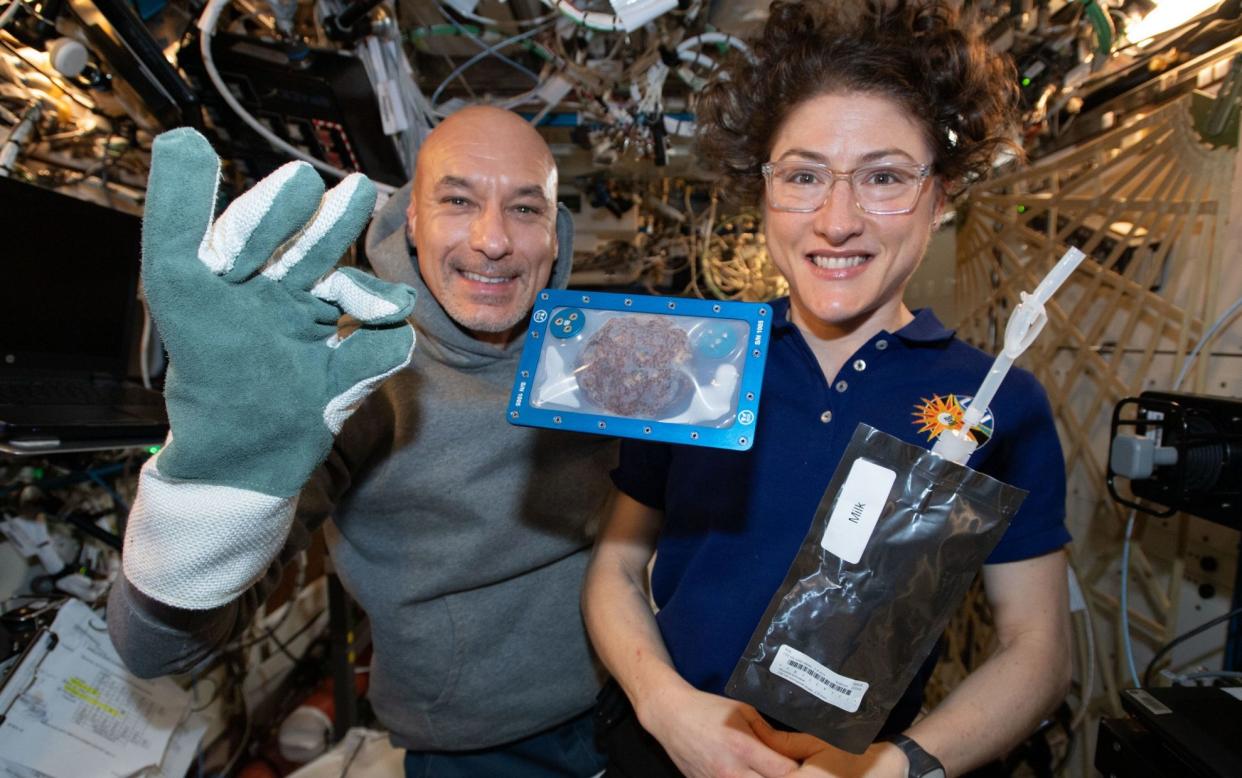 ISS commander Luca Parmitano and astronaut Christina Koch with milk and cookies on board the International Space Station (ISS) in 2019 as chocolate chip cookies have become the first food to be baked in space. PA Photo. Issue date: Thursday January 23, 2020. See PA story SCIENCE Cookies. Photo credit should read: NASA/PA Wire NOTE TO EDITORS: This handout photo may only be used in for editorial reporting purposes for the contemporaneous illustration of events, things or the people in the image or facts mentioned in the caption. Reuse of the picture may require further permission from the copyright holder. - PA/PA