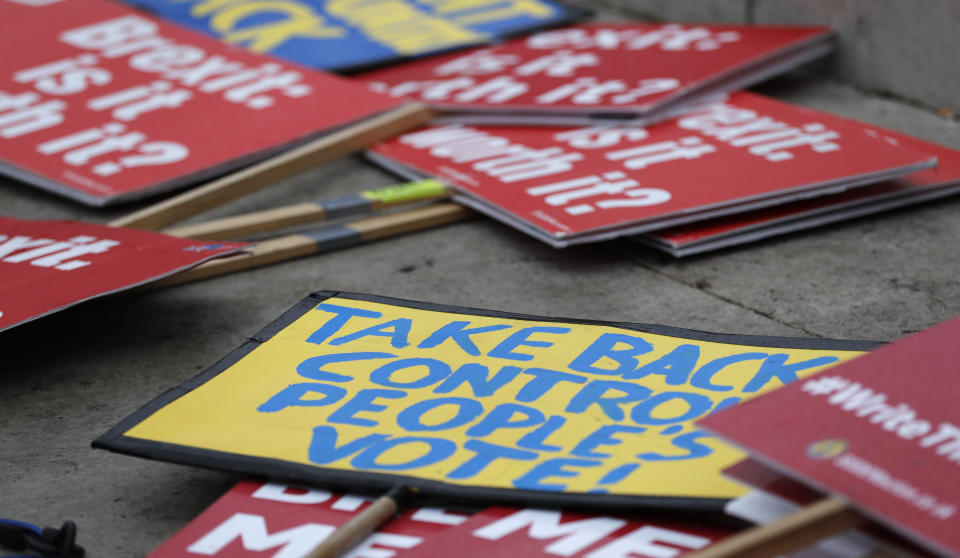 Banners lay on the ground at the demonstration area in London, Wednesday, Jan. 16, 2019. British lawmakers overwhelmingly rejected Prime Minister Theresa May's divorce deal with the European Union on Tuesday, plunging the Brexit process into chaos and triggering a no-confidence vote that could topple her government. (AP Photo/Frank Augstein)