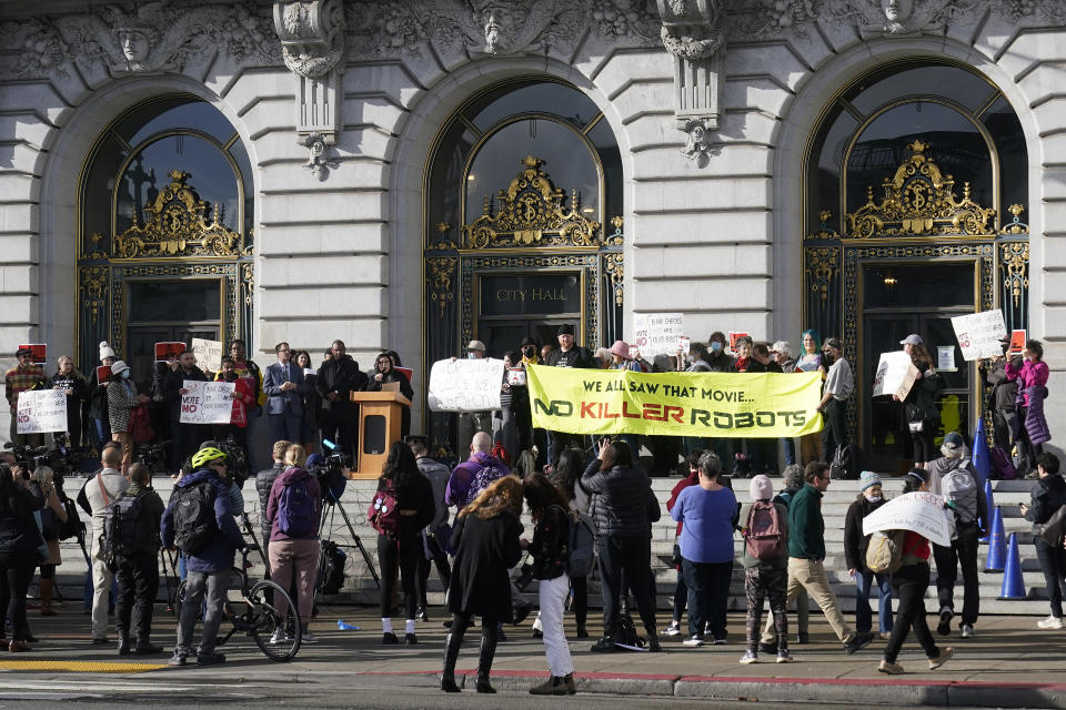 People take part in a demonstration about the use of robots by the San Francisco Police Department outside of City Hall in San Francisco, Monday, Dec. 5, 2022. The unabashedly liberal city of San Francisco became the unlikely proponent of weaponized police robots this week after supervisors approved limited use of the remote-controlled devices, addressing head-on an evolving technology that has become more widely available even if it is rarely deployed to confront suspects. (AP Photo/Jeff Chiu)