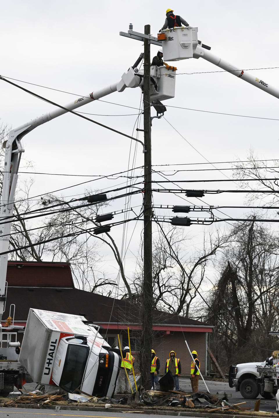 A construction crew repairs a utility pole, Sunday, Dec. 10, 2023, in Clarksville, Tenn. Tornados caused catastrophic damage in Middle Tennessee on Saturday afternoon and evening, Dec. 9. (AP Photo/Mark Zaleski)