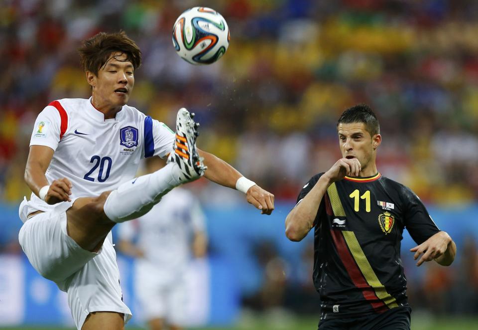 South Korea's Hong fights for the ball with Belgium's Mirallas during their 2014 World Cup Group H soccer match at the Corinthians arena in Sao Paulo