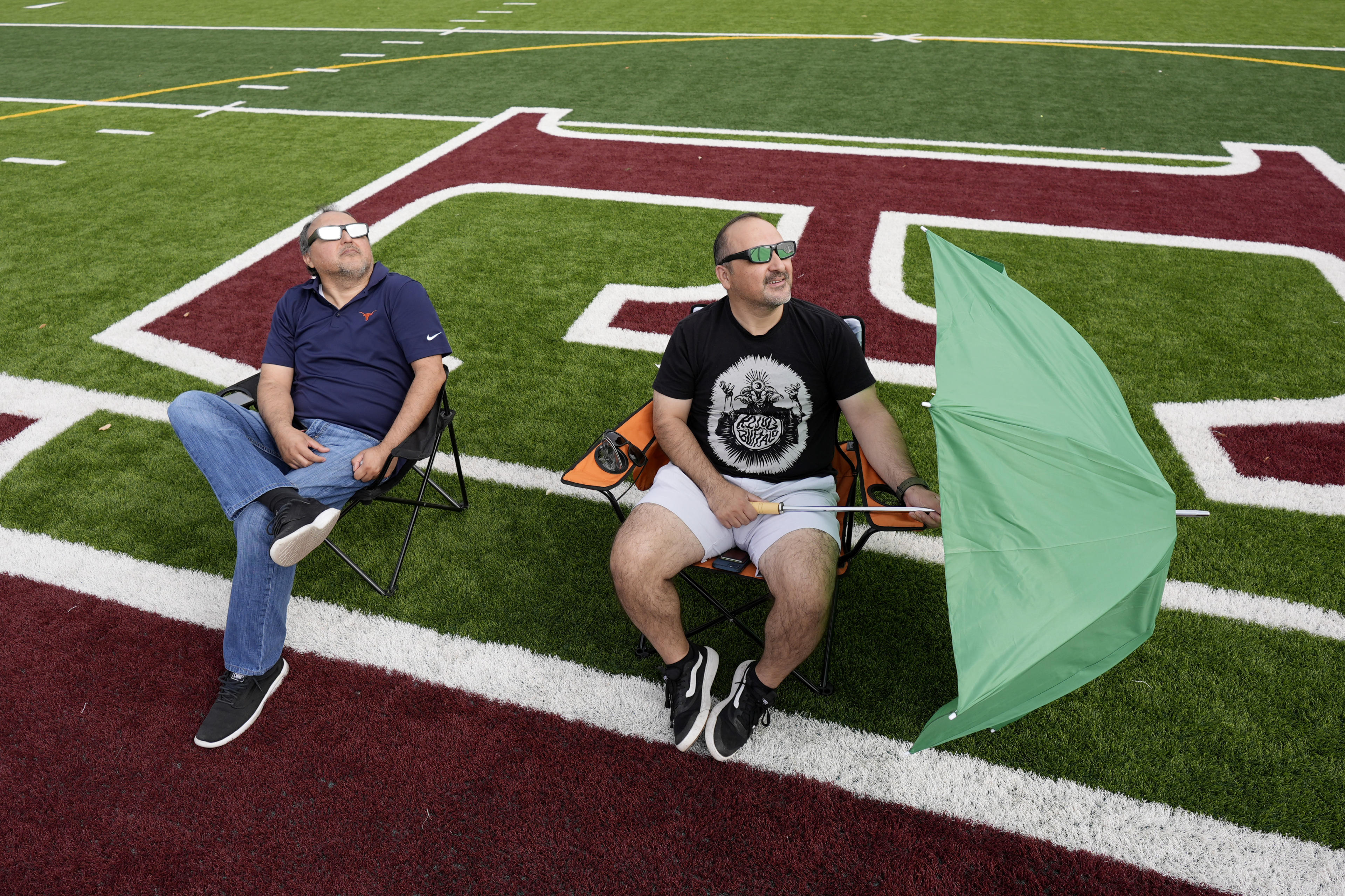 Joe and Ric Solis use special glasses as they prepare to watch a total solar eclipse in Eagle Pass, Texas, Monday, April 8, 2024. (Eric Gay/AP)