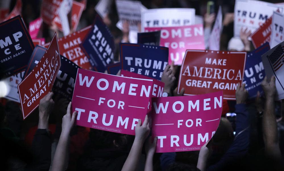 Supporters hold ‘Women for Trump’ signs before a campaign rally for the presidential candidate on 7 November 2016, in Manchester, New Hampshire.