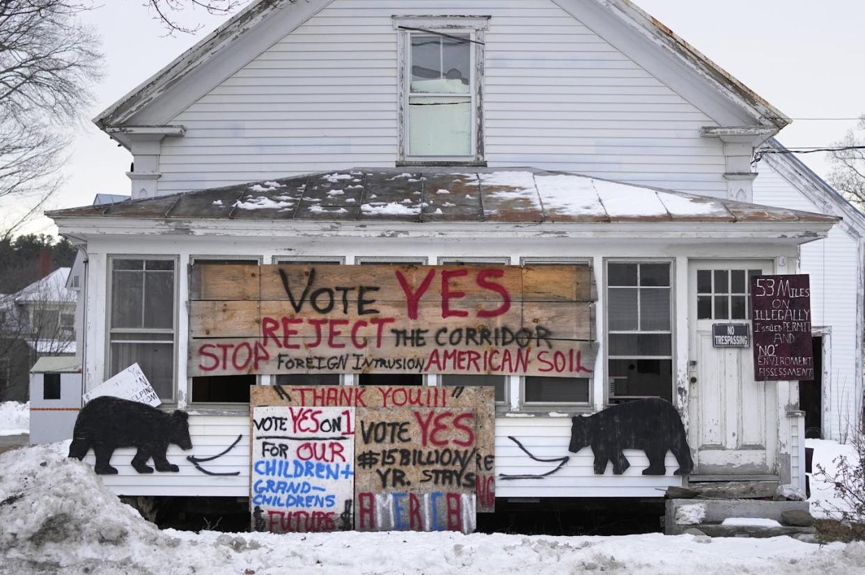 A home in rural Bingham, Maine, displays signs protesting a Quebec-to-New England hydropower corridor that voters rejected in a referendum vote. <a href="https://newsroom.ap.org/detail/ElectionMaineUtilityReferendum/756beb8c0d884d4b9402ebbe911a140b/photo?Query=referendum%20voting%20state&mediaType=photo&sortBy=&dateRange=Anytime&totalCount=416&currentItemNo=131" rel="nofollow noopener" target="_blank" data-ylk="slk:AP Photo/Robert F. Bukaty;elm:context_link;itc:0;sec:content-canvas" class="link ">AP Photo/Robert F. Bukaty</a>