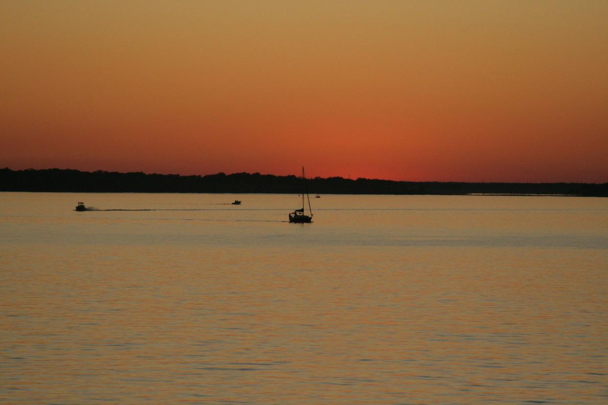 boats at sunset on lake