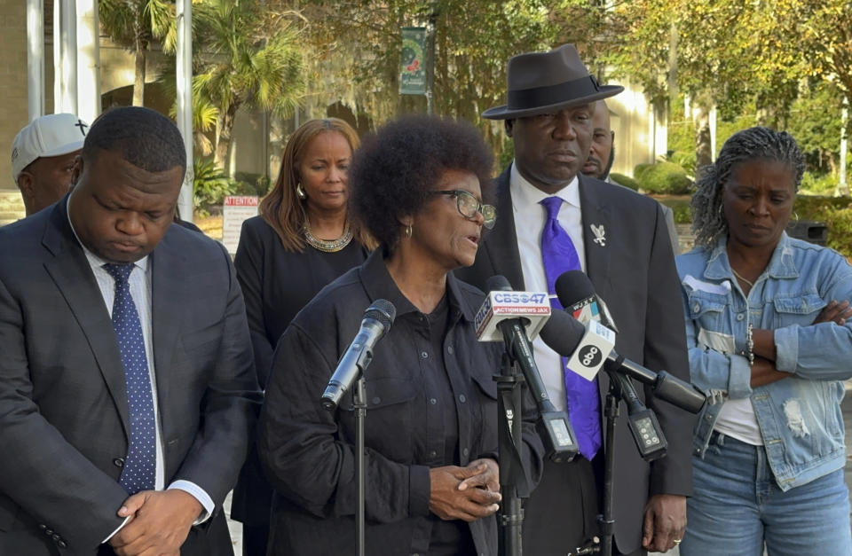 Mary Cure speaks to reporters flanked by her family's attorneys, Harry Daniels, left, and Ben Crump, right, at a news conference Tuesday, Dec. 5, 2023, in Woodbine, Georgia, announcing their intention to file suit against the Camden County Sheriff's Office for the death of her son, Leonard Cure. A deputy fatally shot Leonard Cure after pulling him over on suspicion of speeding and reckless driving, Oct. 17, 2023. (AP photo/Russ Bynum)