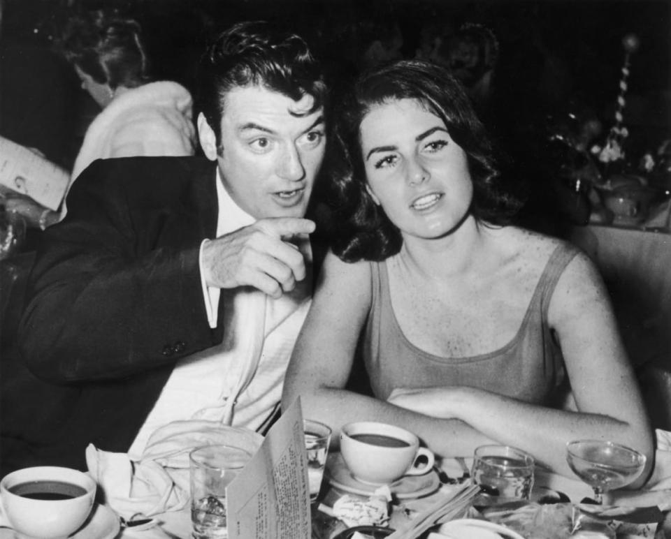 <div class="inline-image__caption"><p>circa 1955: American actor William Campbell sits with his wife Judith Campbell at a table, pointing, during the Deb Star Ball.</p></div> <div class="inline-image__credit">Hulton Archive/Getty</div>