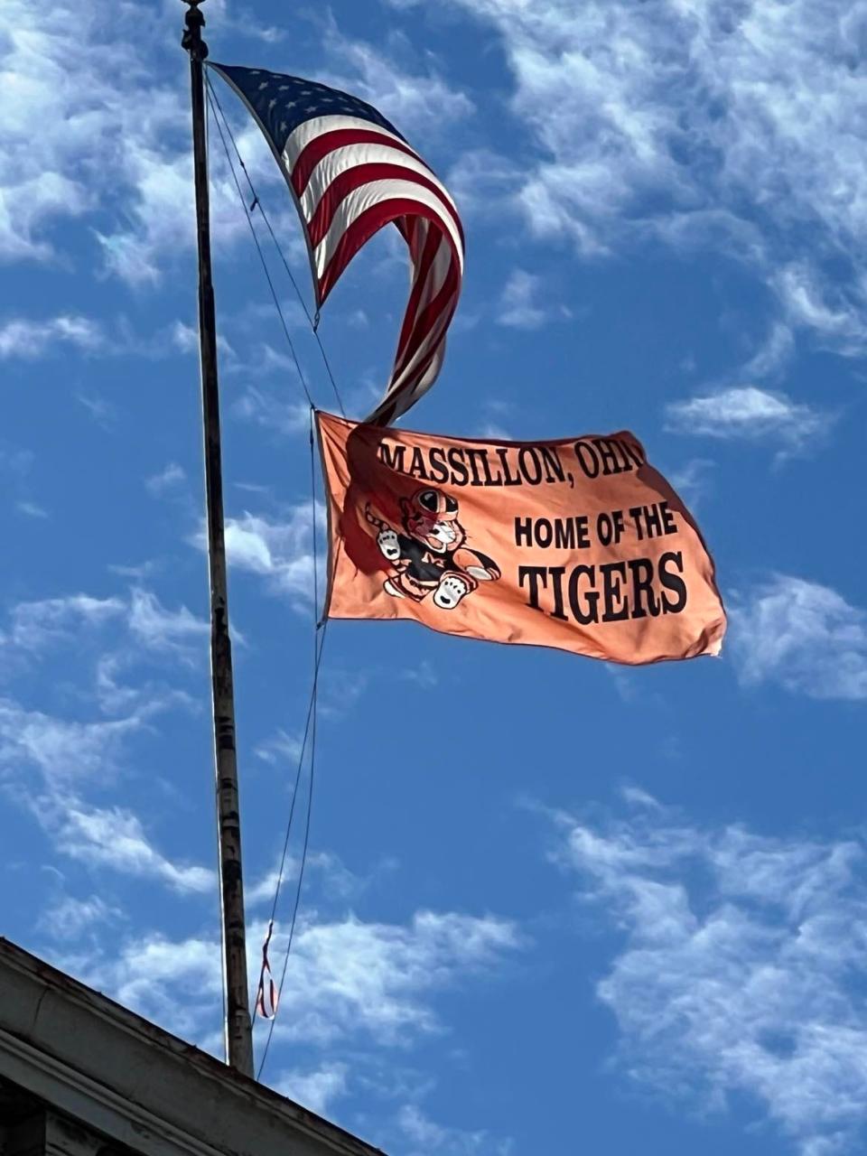 A Massillon Tigers flag waves atop a downtown building this past weekend. The Tigers high school football team has advanced to the state finals against Hoban.