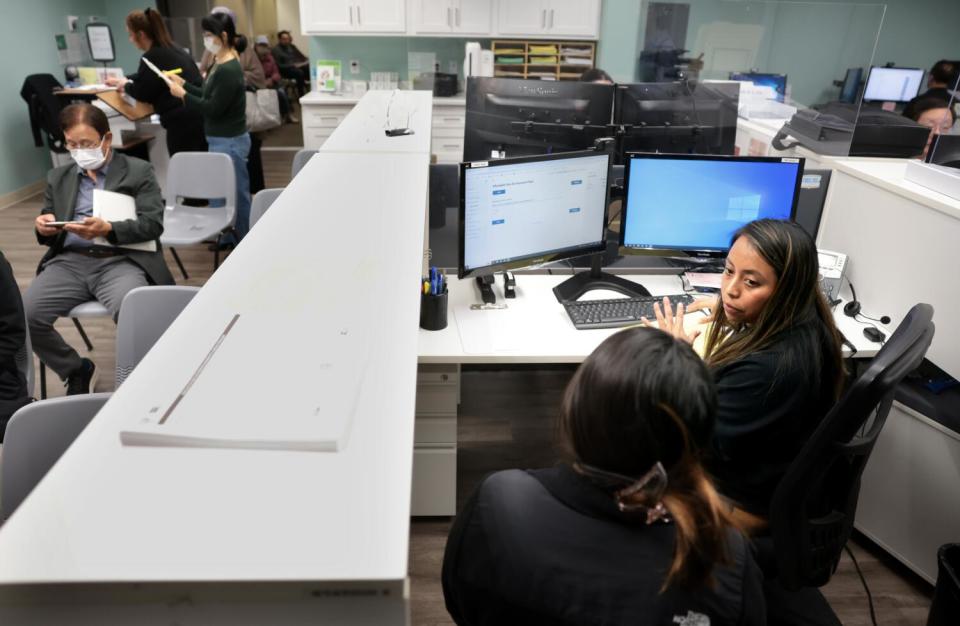 Tax preparer Lidia Sebastian helps a customer with her taxes.