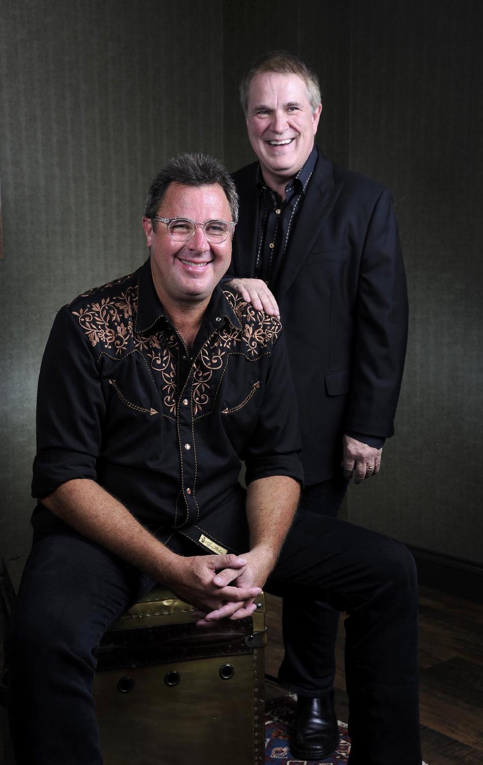 This Saturday, July 27, 2013 photo shows Vince Gill, left, and Paul Franklin posing at the Grand Ole Opry in Nashville, Tenn. Gill and Franklin released their latest album "Bakersfield," on July 30. (Photo by Donn Jones/Invision/AP)