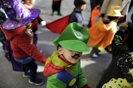 Children in costumes arrive at a residential community for an event celebrating Halloween in Beijing, China, October 30, 2015. REUTERS/Jason Lee/Files