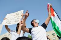 Jordanians demonstrate to express solidarity with the Palestinian people, near the Israeli embassy in Amman