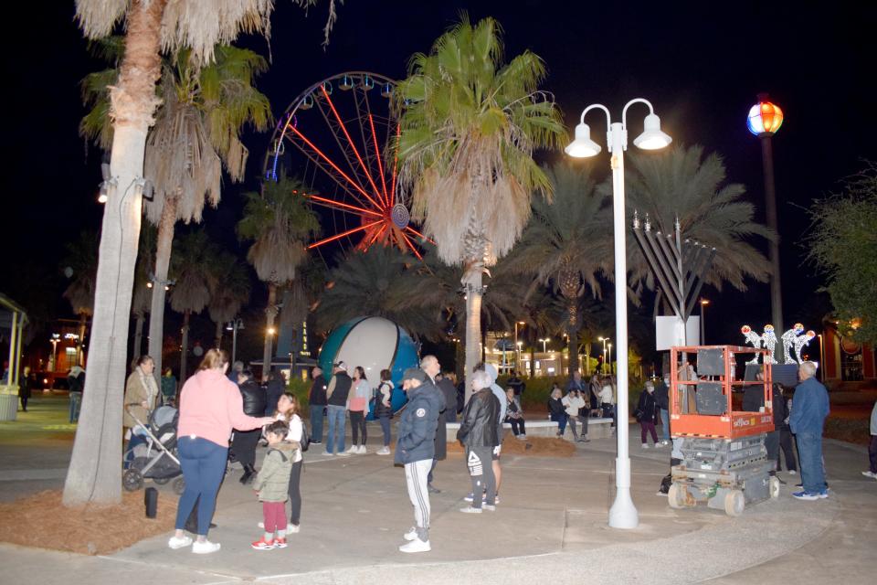 Dozens of people gathered in front of the Grand Theatre in Pier Park on Monday night for the third annual Grand Menorah Lighting Event.